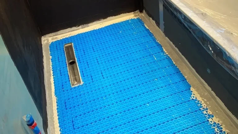 Underfloor heating mat fitted around a shower drain before tiling