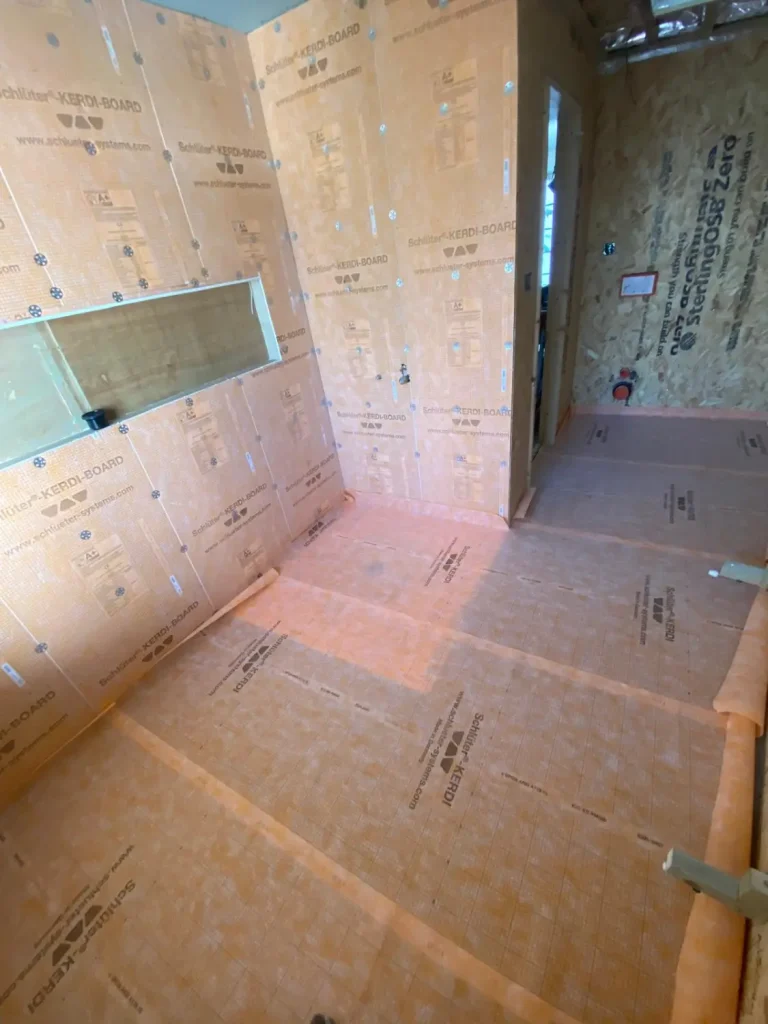Waterproofed wet room floor with Schluter Kerdi board and drain detail before tiling