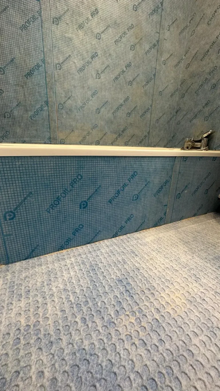 Schluter Kerdi board waterproofing installed across wet room walls and floor