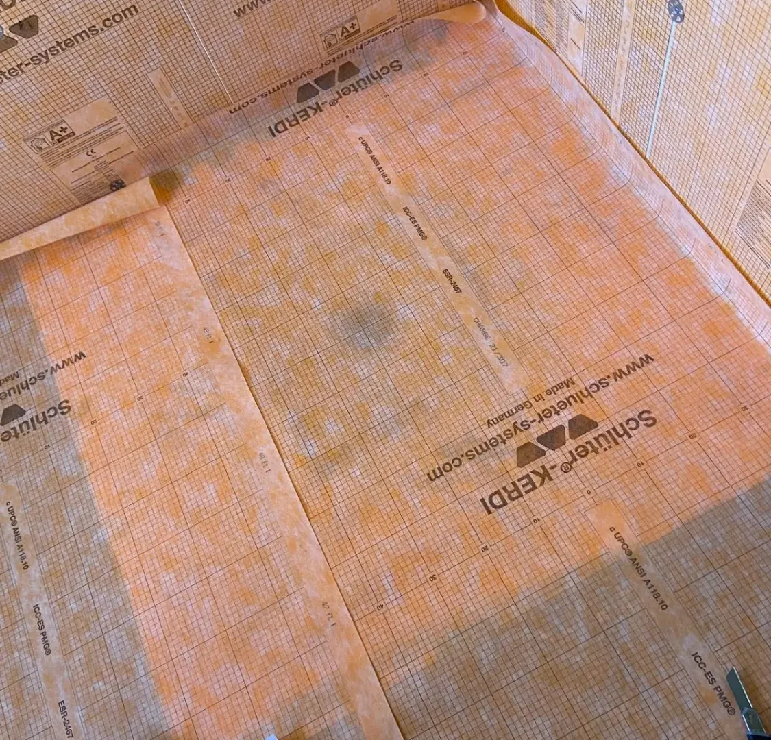 Bathroom waterproofing membrane installed around a bath surround before tiling