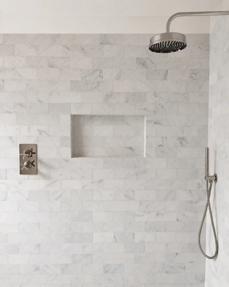 Chiswick en-suite marble shower wall with recessed niche, rain head and handheld shower.
