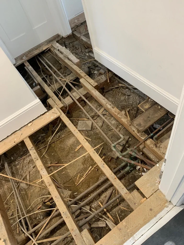 Chiswick ground-floor suspended timber floor exposed before restoration.