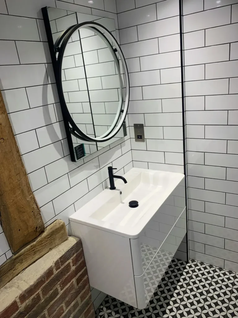 Surrey barn conversion shower tray installation with exposed wall framing and insulation