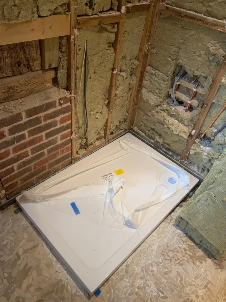 Surrey barn conversion bathroom strip out with exposed frame, concealed cistern and first fix plumbing