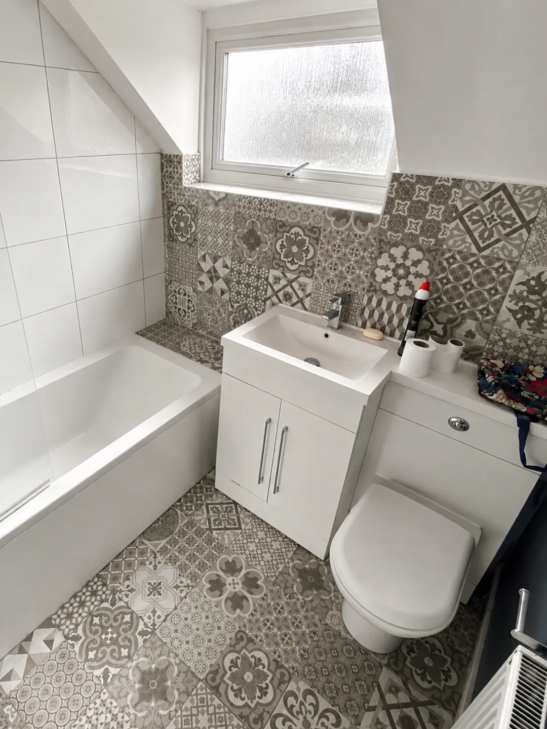 Before photo of Twickenham full bathroom renovation with patterned grey wall and floor tiles