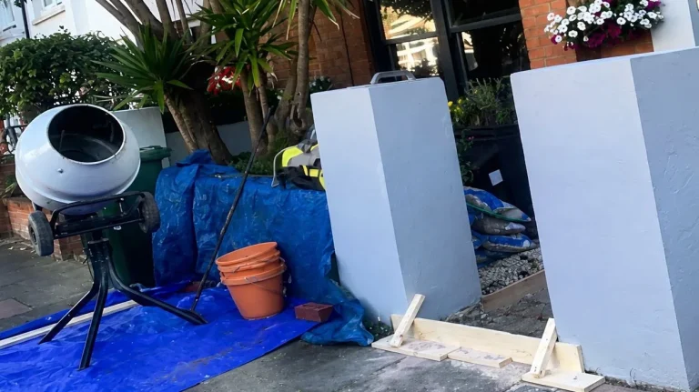 Front path entrance prepared for porcelain tile installation with shuttering, tools and materials in place.