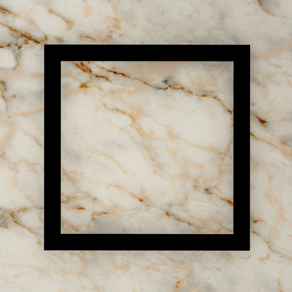 Prima VENTUS extractor cover set flush into a marble-effect tiled wall.