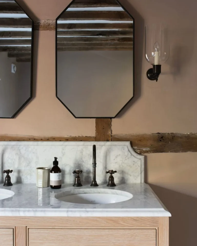 Period home marble vanity with twin mirrors, traditional taps and exposed timber beams